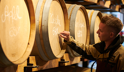 Prinz Holzfass wird für Destillatlagerung beschriftet